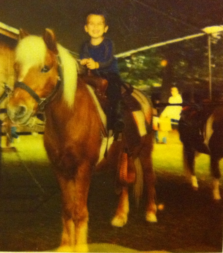 Joshua riding a pony when he was about 3 years old.